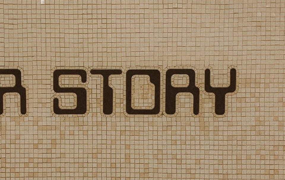 a tiled wall with the words yots aloy on it