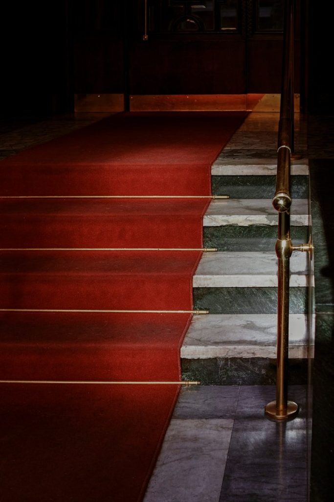 red concrete staircase with stainless steel railings