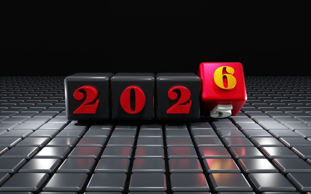 Black cubes with red numbers 2026 on textured surface